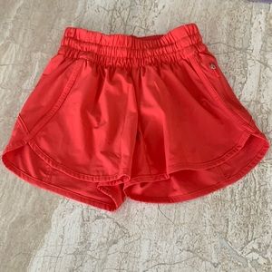 Very pretty bright reddish orange Lululemon 4 inch tracker shorts, Size 0